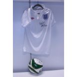 A signed England t-shirt and football by goal keeper Peter Shilton