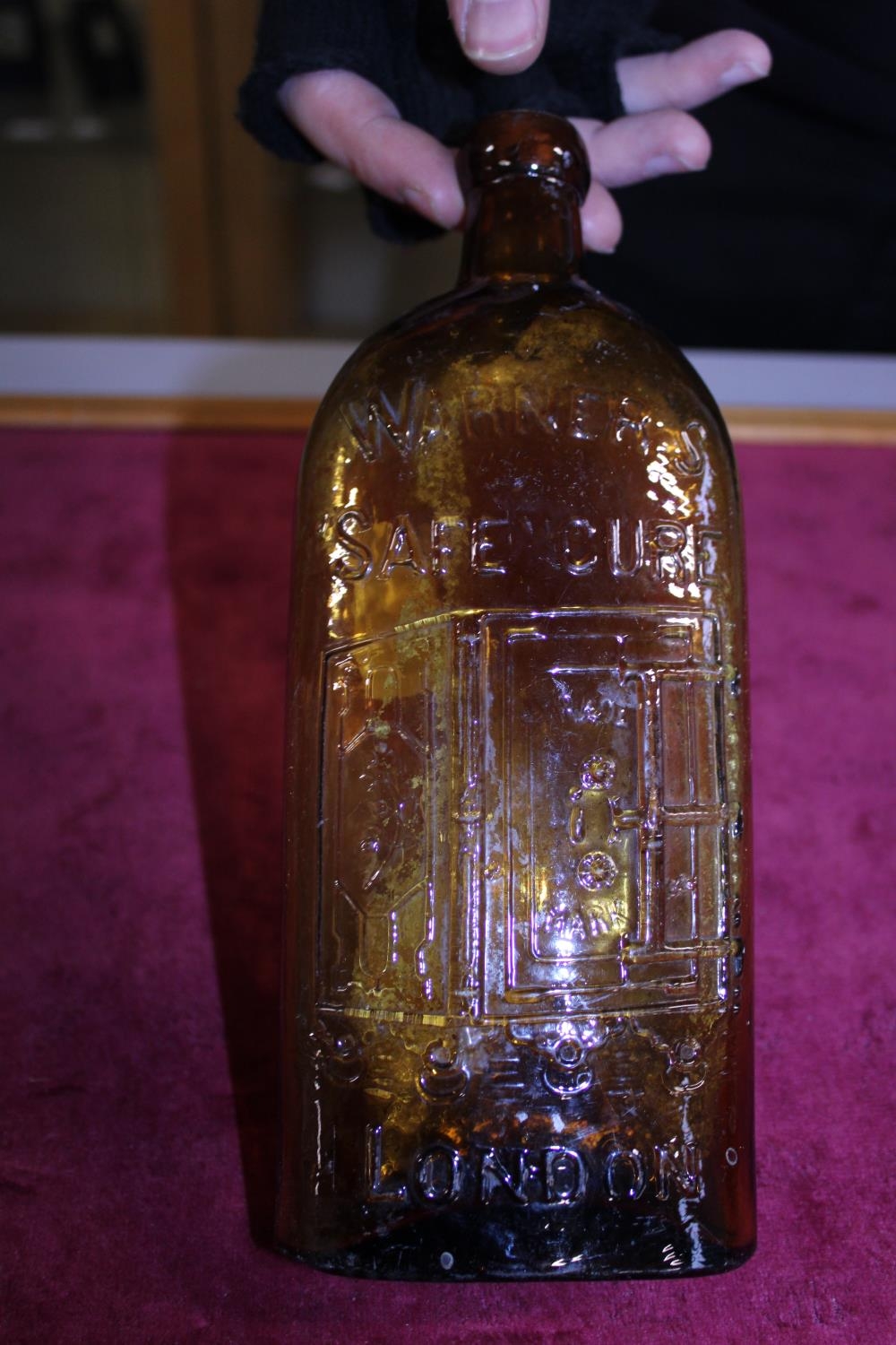 A antique Warner's of London Safe Cure amber coloured bottled (slight chip to rim)