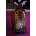A antique Warner's of London Safe Cure amber coloured bottled (slight chip to rim)