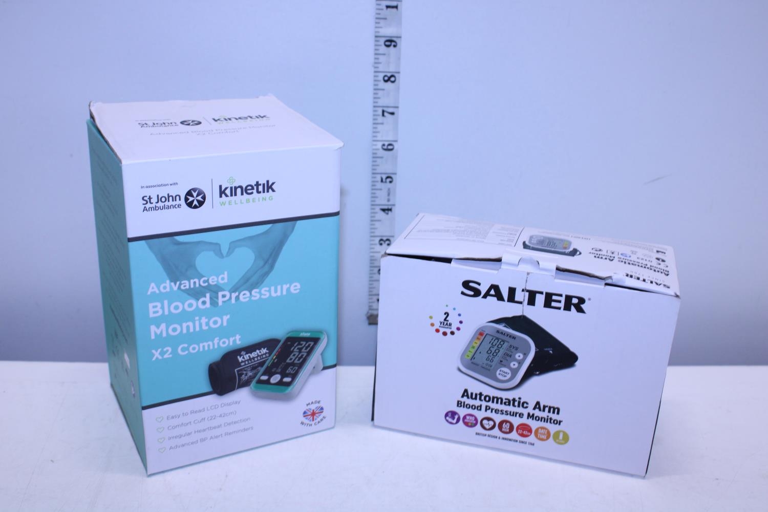 Two boxed blood pressure monitors