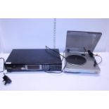 A Phillips compact disc player and a Bush turntable. Shipping unavailable