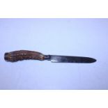 A vintage horn handled bread knife with a sliver top