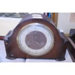 A vintage wooden cased mantel clock