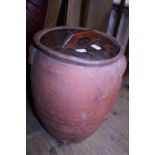 A large terracotta storage jar with lid. Postage unavailable