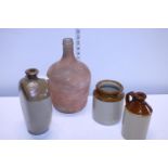 A glass bottle and three pieces of vintage stoneware