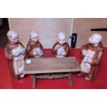 A set of four ceramic monk themed decanters made in Germany and table.