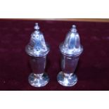 A pair of hallmarked silver salt and peppers 90 grams