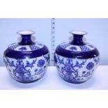 A pair of antique James MacIntyre blue and white Florian style vases.