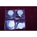 Four 1964 American half dollar coins