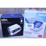 Two boxed blood pressure monitors