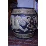 A large heavy vintage Chinese ironstone storage jar with dragon detailing imported into Thailand,