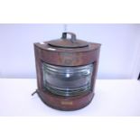 A antique copper ships lantern has been converted for electric use