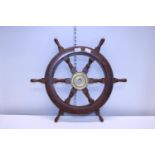 A wooden and brass ships wheel