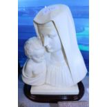 A Madonna and child resin figure