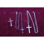 Three silver crosses two on silver chains