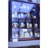 A display case full of miniature carriage clocks