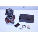 A vintage mechanical moneybox and box of assorted collectables