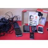 A box of assorted mobile phones and charges