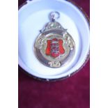 A antique 9ct gold fob medal with enamel decoration