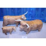 Three Beswick cow figures (one with damage to horn)