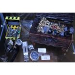 A shelf of assorted costume jewellery including cufflinks and watches