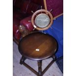 A vintage wooden coffee table and a ships wheel barometer (has crack to glass), shipping unavailable