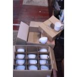 A box of 6x6 bone china stacking mugs and a box of cappacinno style mugs