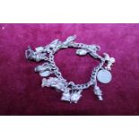 A silver bracelet with white metal charms total weight 65g