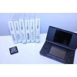 A Nintendo DS with six games including a Pokeman black game(uncased), (untested)