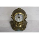 A novelty brass clock in the form of a divers helmet