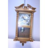 A pine cased Vienna style wall clock. Shipping unavailable