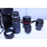 Three assorted camera lenses including Tamron and Yashica