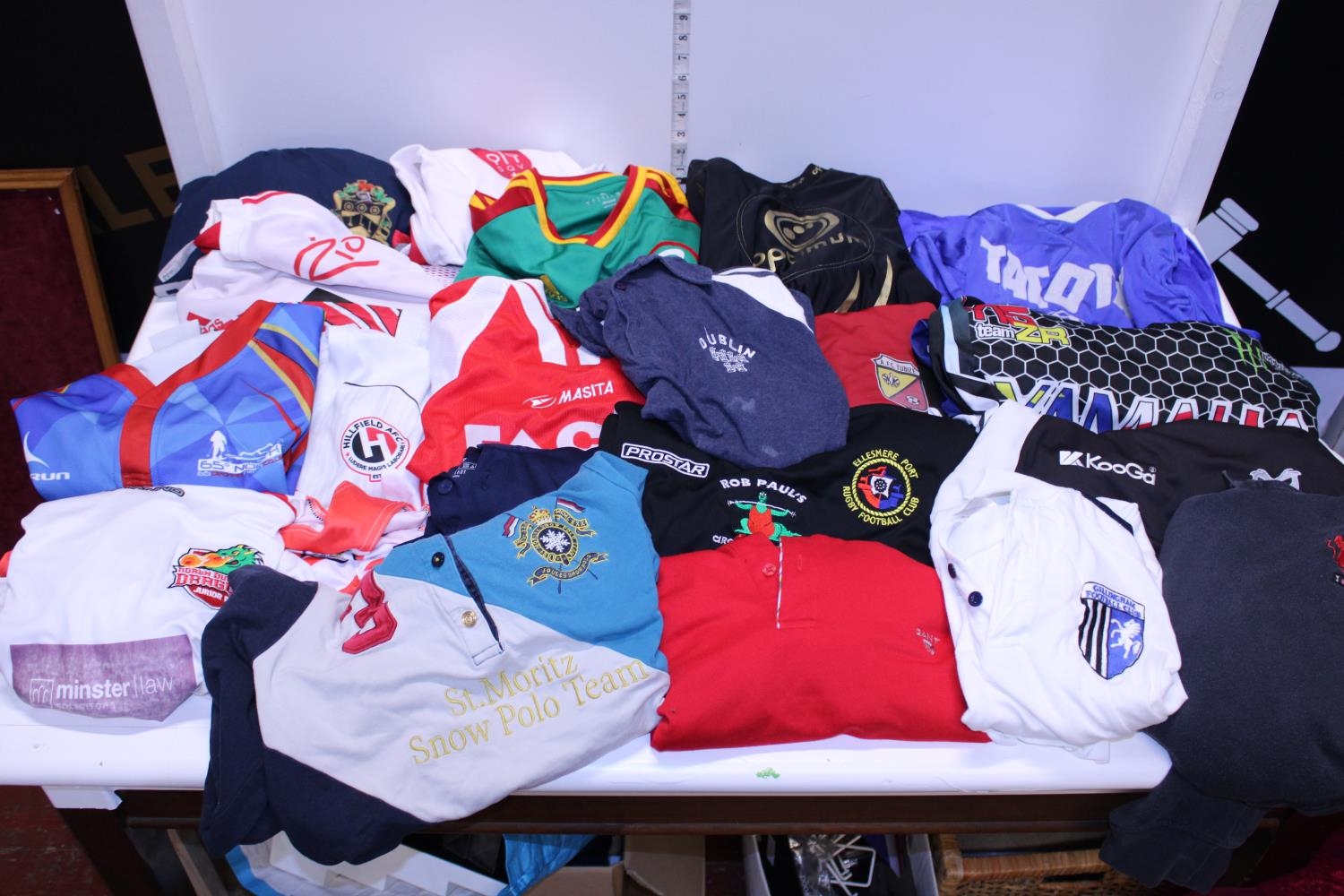 A large job lot of assorted sports shirts