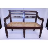 A antique child's bench with cane work seat. Shipping unavailable