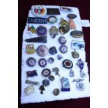 A selection of assorted enamel badges
