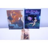 Two Alpha Blue books and one other