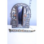 A bone decorated wall mirror and ornate dagger