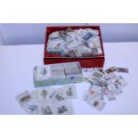A large selection of loose cigarette cards
