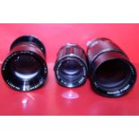 Three assorted camera lenses