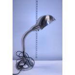 A modern flexible brushed steel desk lamp