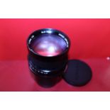 A cased Komura camera lens F=150m