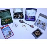 A selection of costume jewellery and enamels badges etc