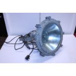 A 1940s industrial flameproof floodlight by GEC with bracket, shipping unavailable