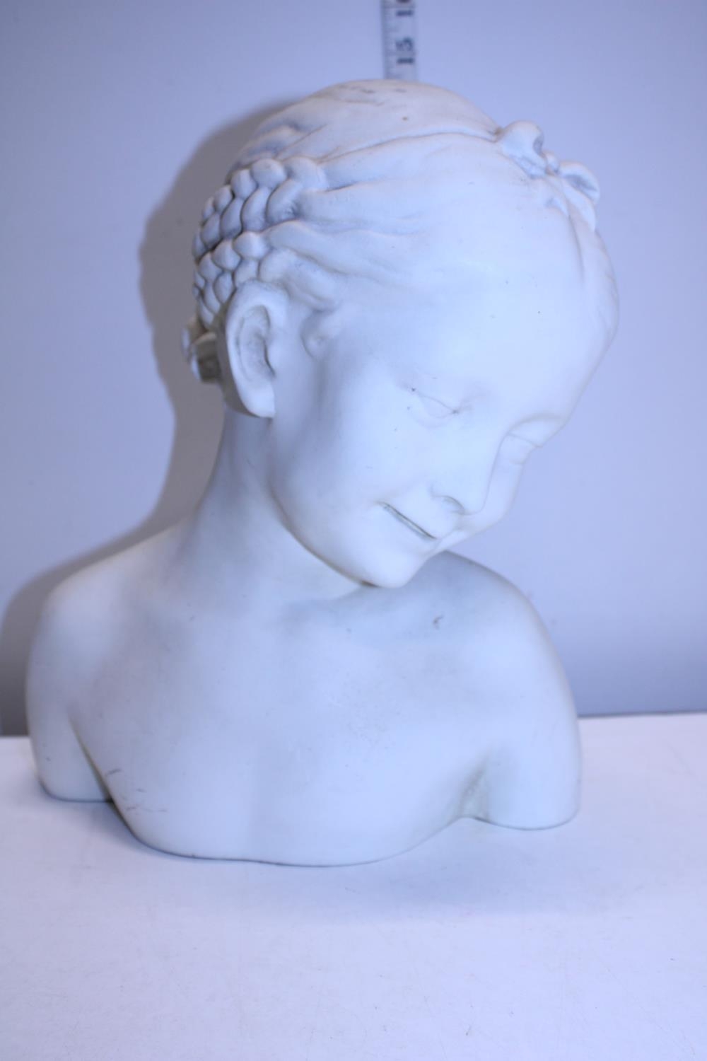 A large resin bust of a young girl