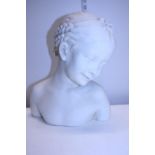 A large resin bust of a young girl