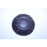 A Chinese Buddhist saucer carved in wood with a pewter liner