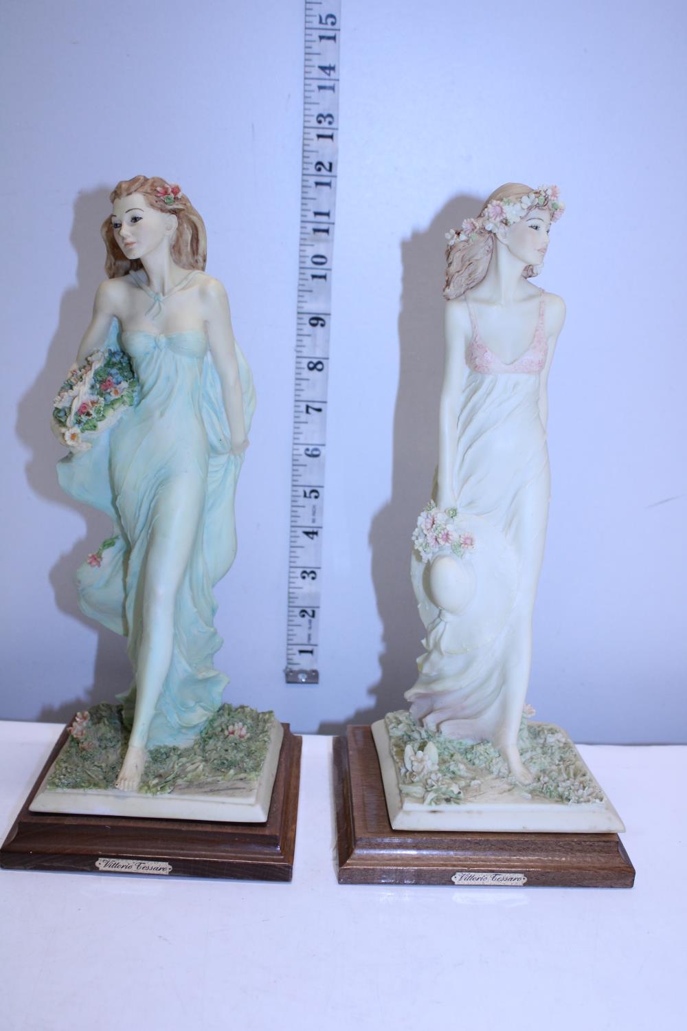 A pair of resin figures on stands