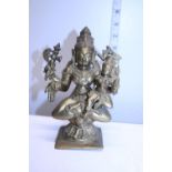A Oriental heavy gilt brass deity figure