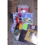 A box of mixed genre LP records