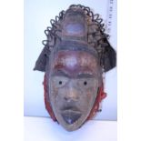 A unusual hand carved antique wooden tribal mask